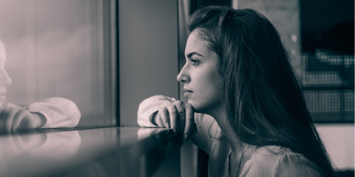 woman looking out window