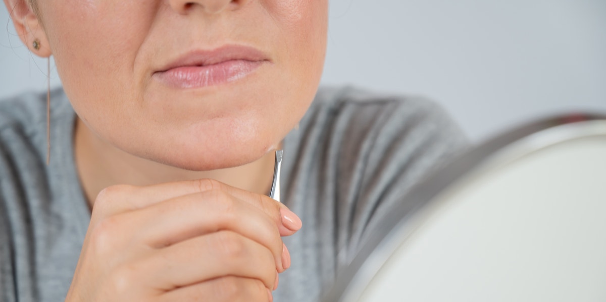 woman plucking chin hair