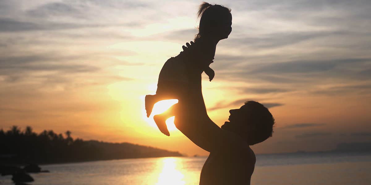 dad holding daughter 