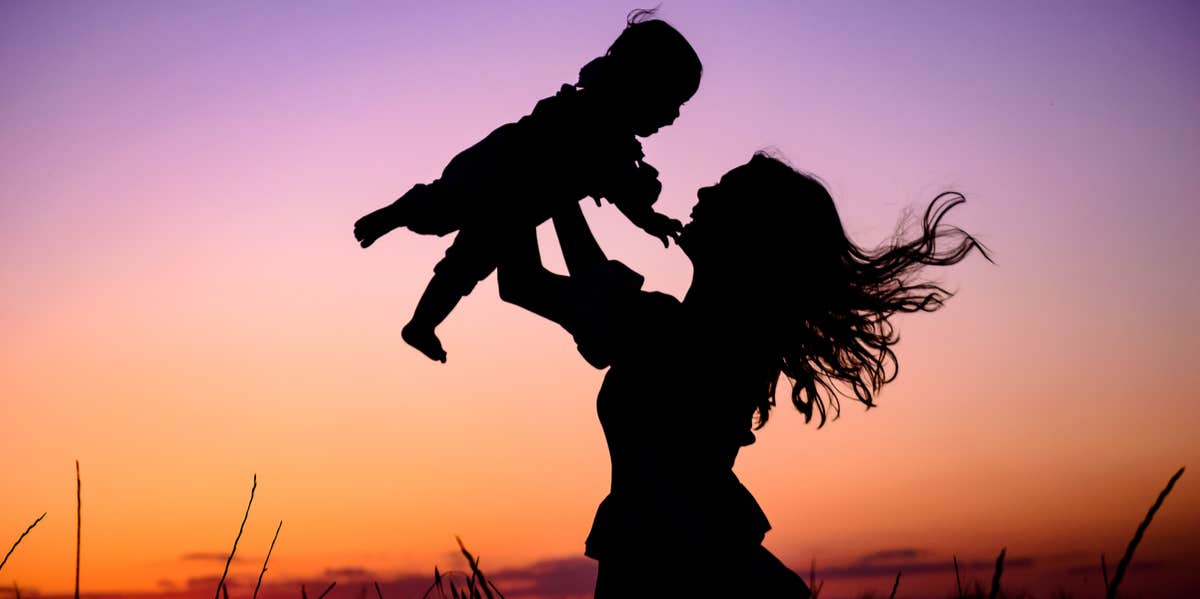 mom throwing baby in air