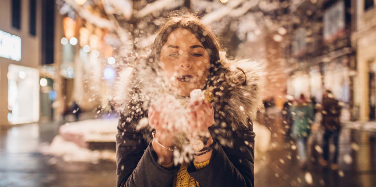 woman blowing snow away