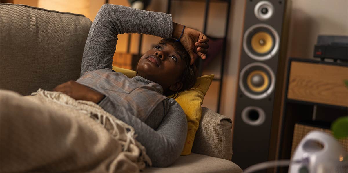 How Having An Absent Father Fundamentally Changes Your Brain sad woman laying on couch thinking
