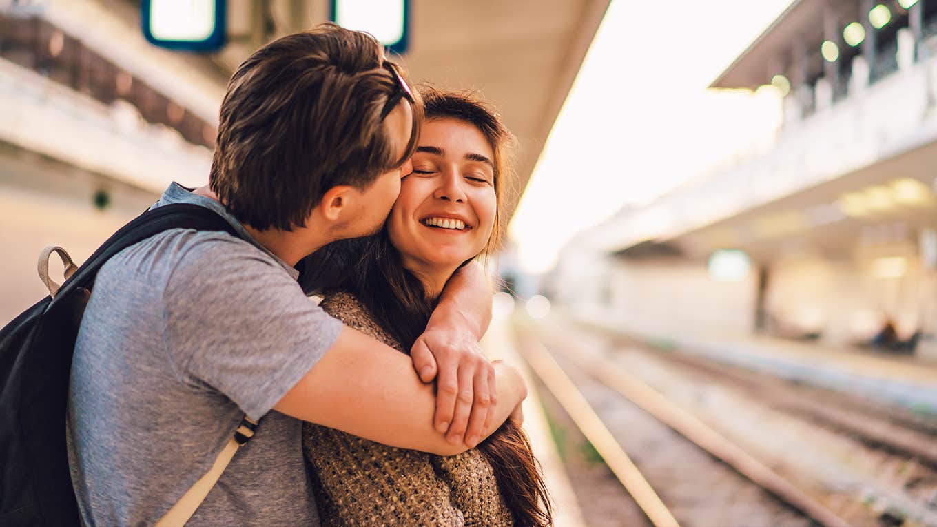 A young couple meeting at the central station.