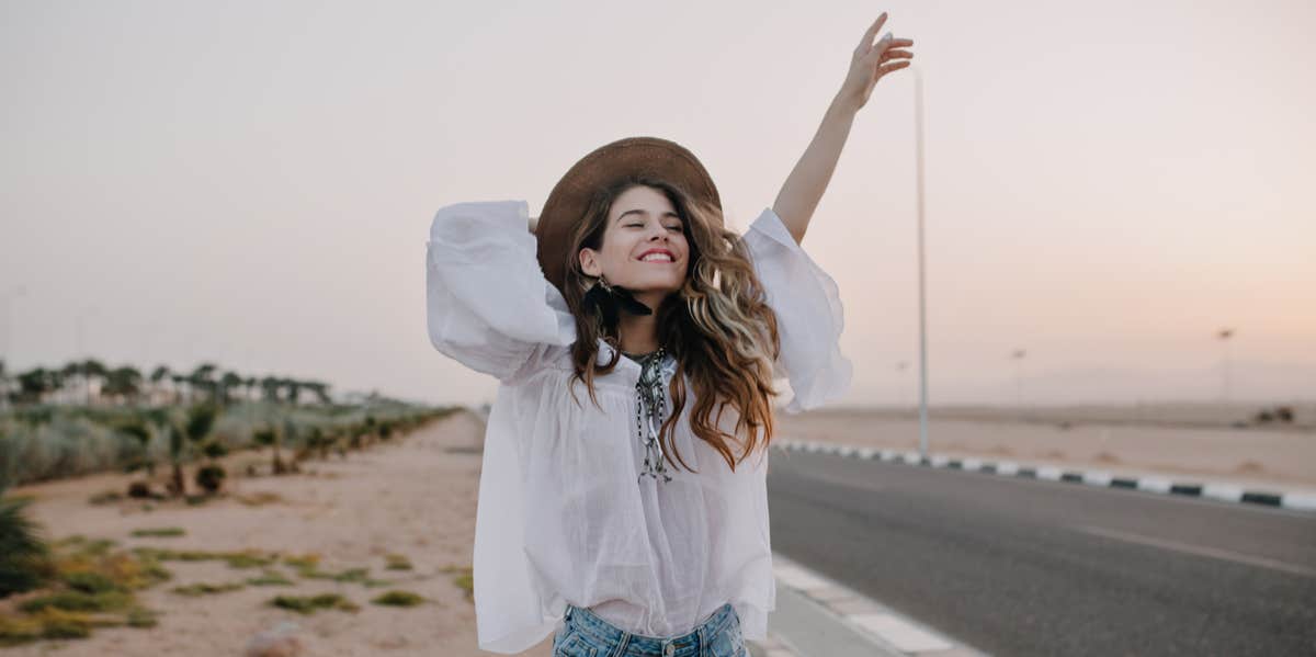 Why You Should Never Have To Defend Your Choice To Be Single Woman smiling by roadway