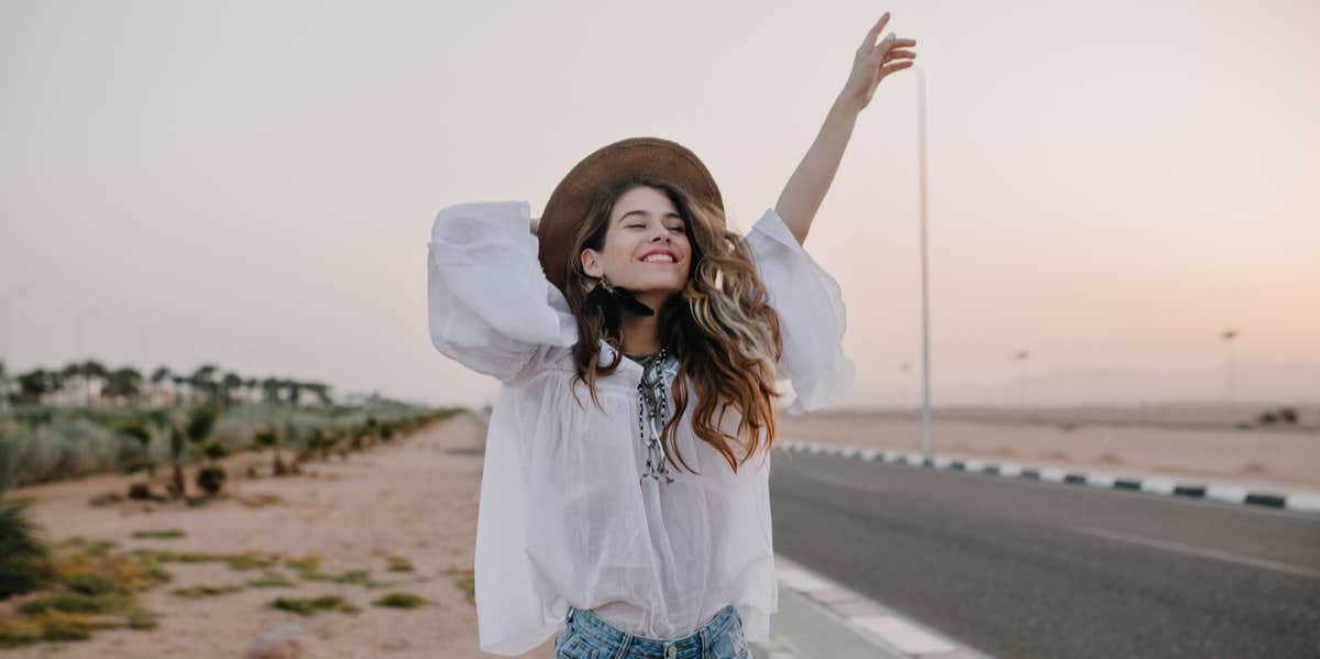 Woman smiling by roadway