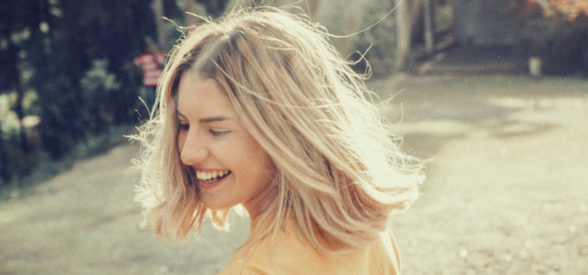 woman laughing in field