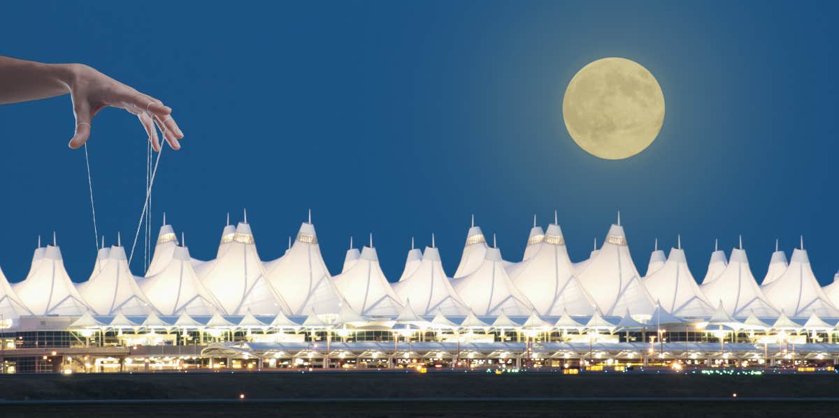 denver airport and hand pulling strings