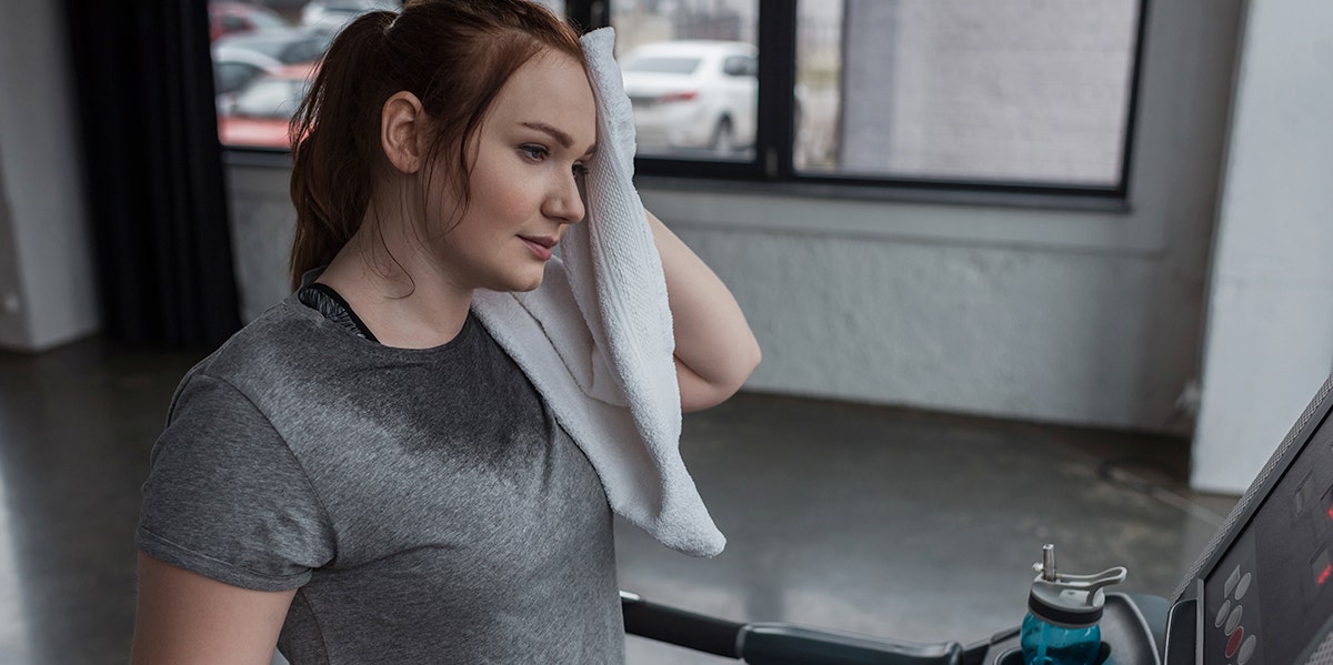 What Happened To My Love Life When I Stopped Wearing Deodorant woman sweating on a treadmill