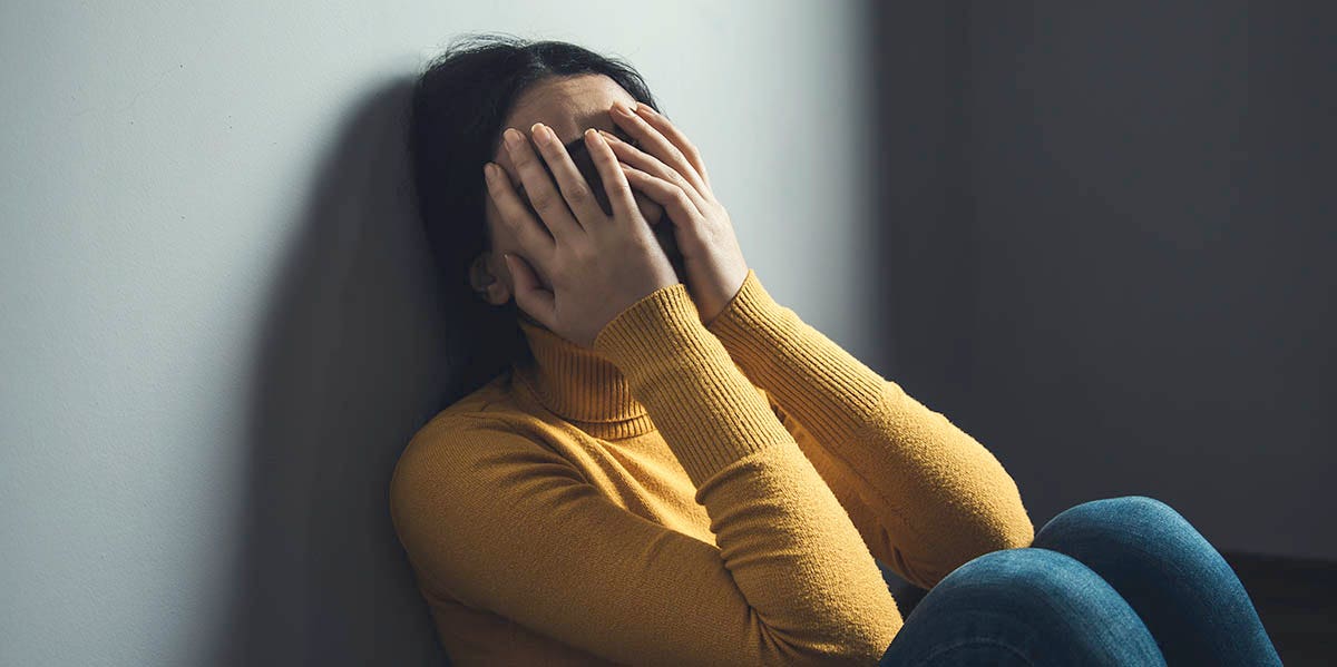 'Put On A Happy Face': How I Manage Severe Depression As A Mom woman with hand over eyes