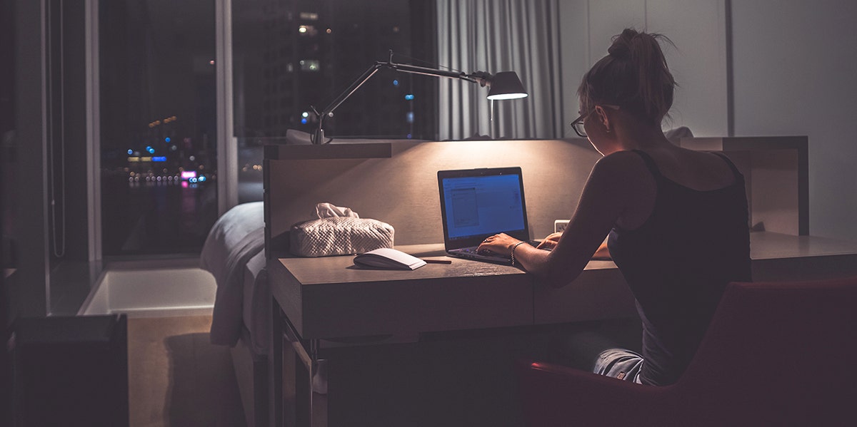 Woman sitting at her desk in the dark