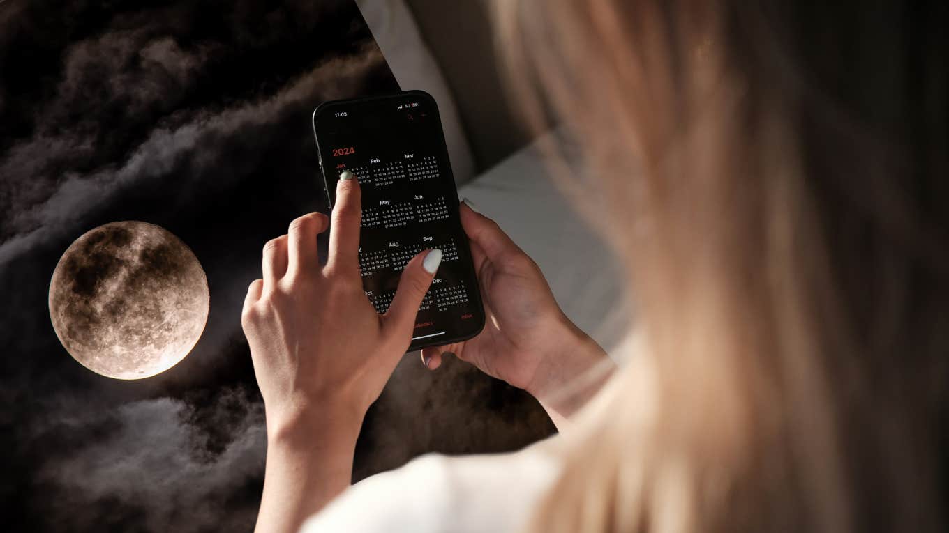 woman using calendar app on phone and full moon