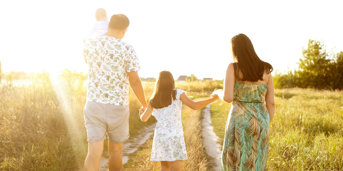 family walking with kids in field