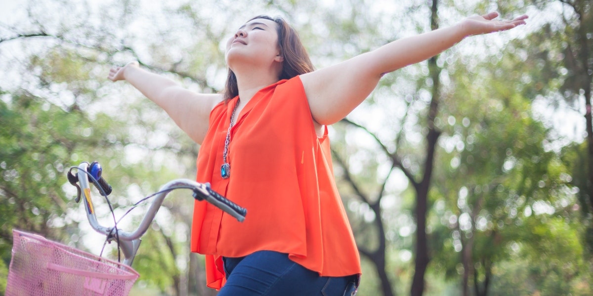 dieting is bad woman on a bike and stretching her arms