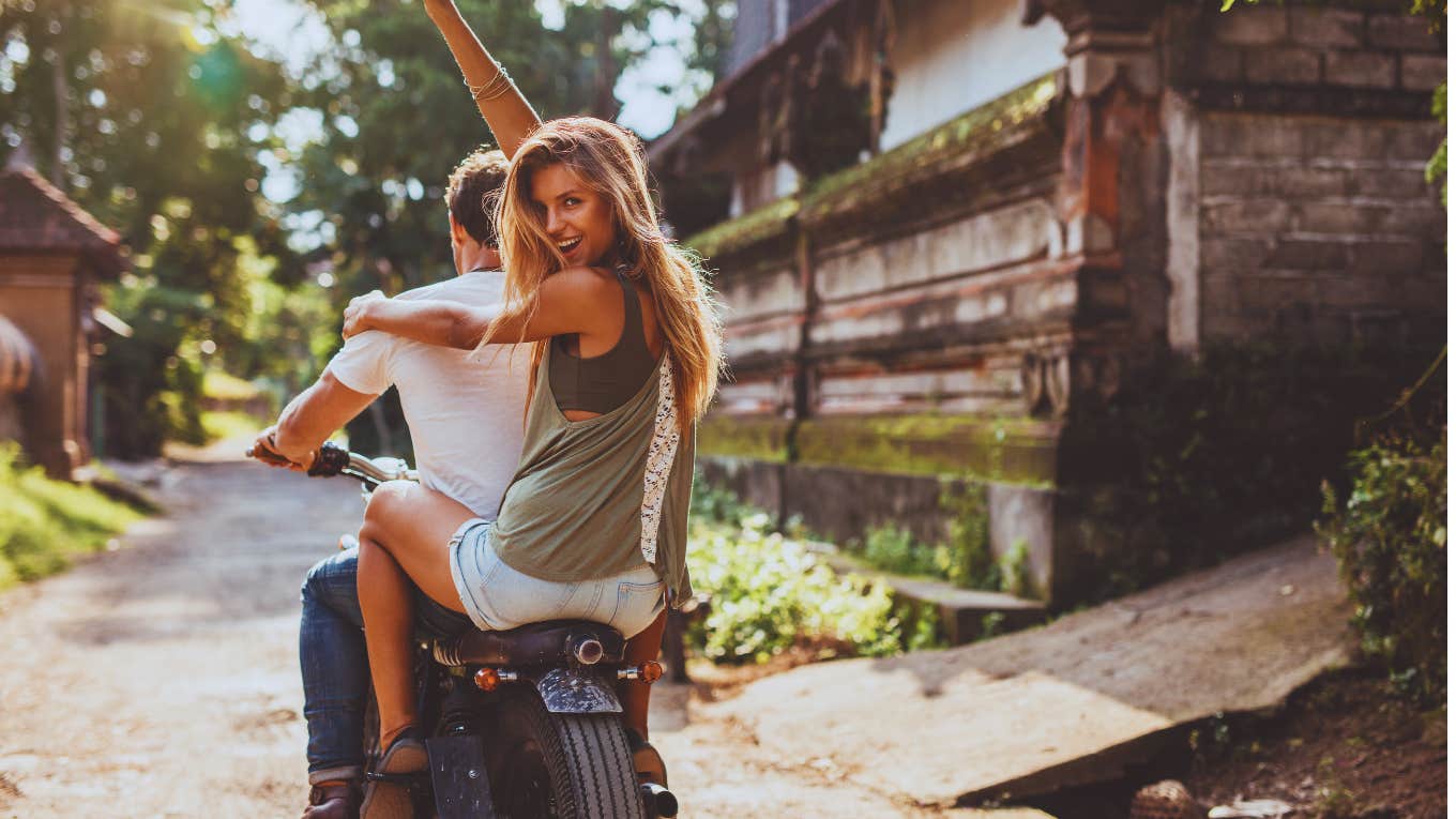 woman on back of motorcycle