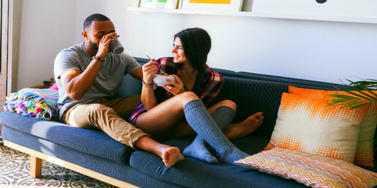 couple on couch laughing smiling