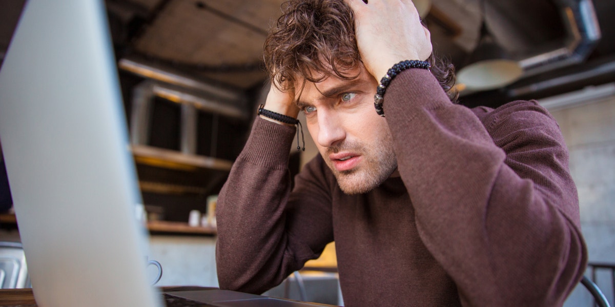 man confused looking at computer