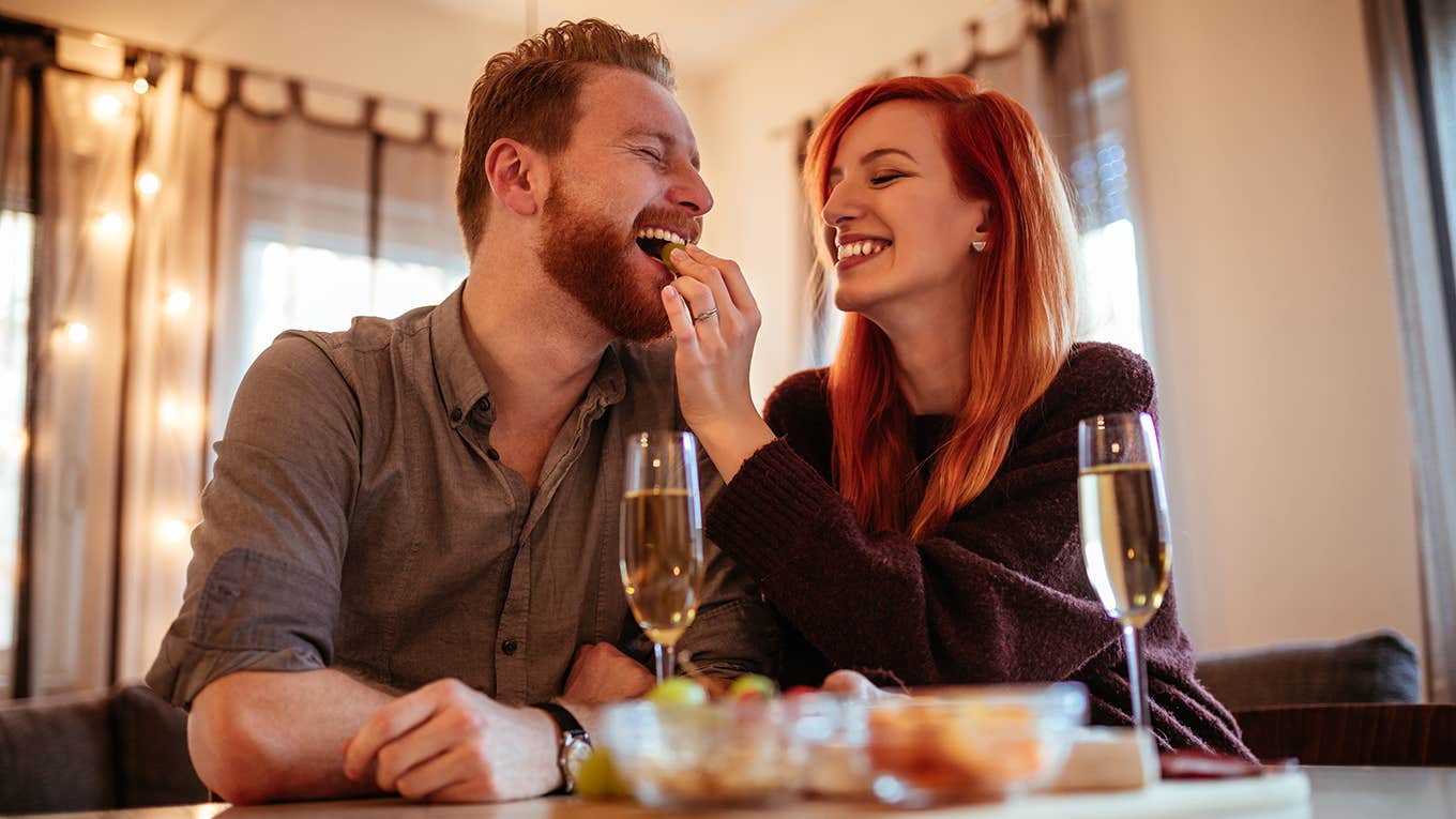 Photo of young couple enjoying spending time together dating at home.