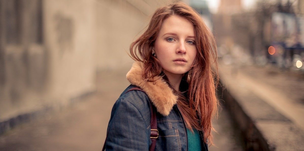 red haired woman looking at the camera