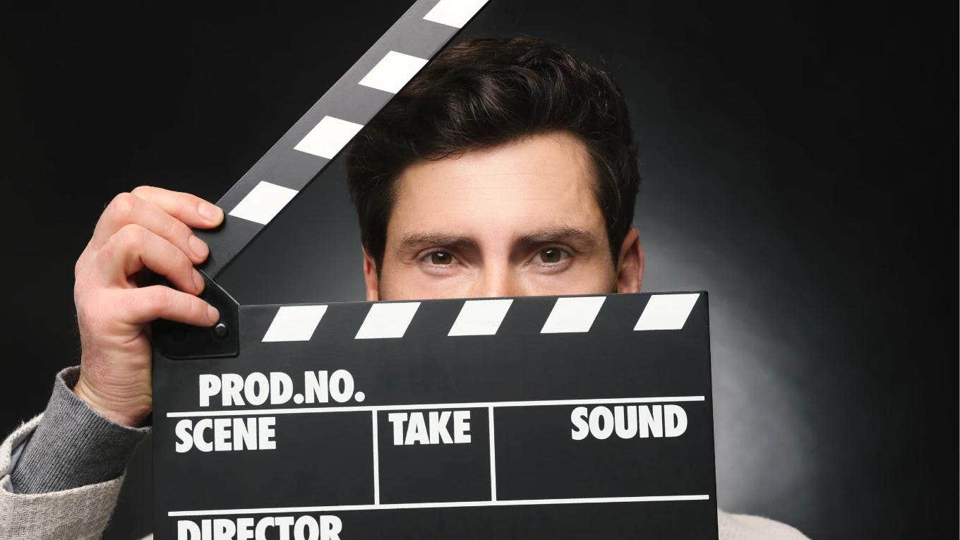 actor holding film clapper