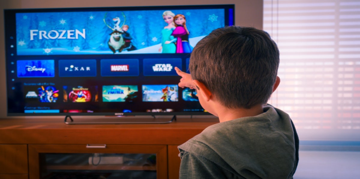 boy pointing to Disney's Frozen on the TV