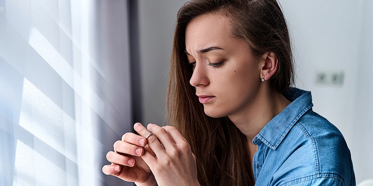 woman taking off wedding ring