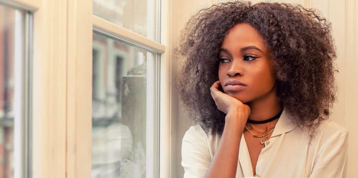 sad woman looking out the window