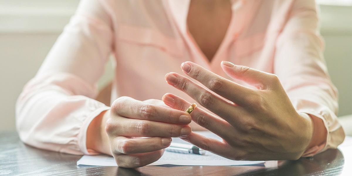 DivorceLand: You Can Check Out Any Time, But You Can Never Leave woman taking off wedding ring