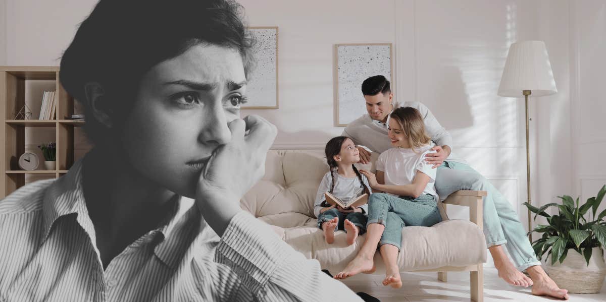 woman upset while holding head in chin, family sitting in living room