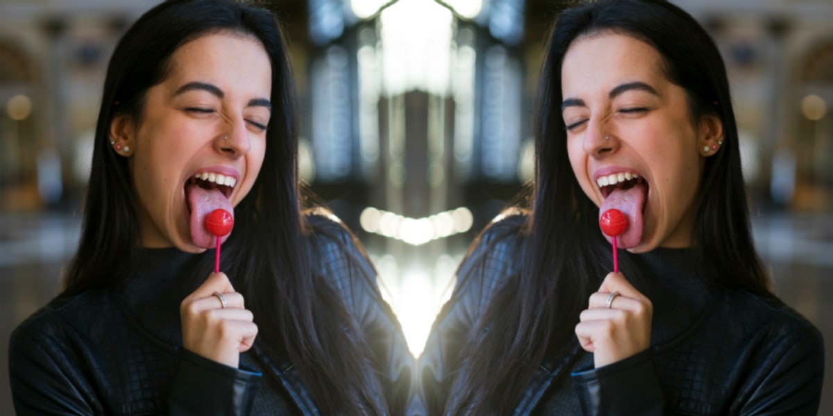 woman with lollipop in her mouth