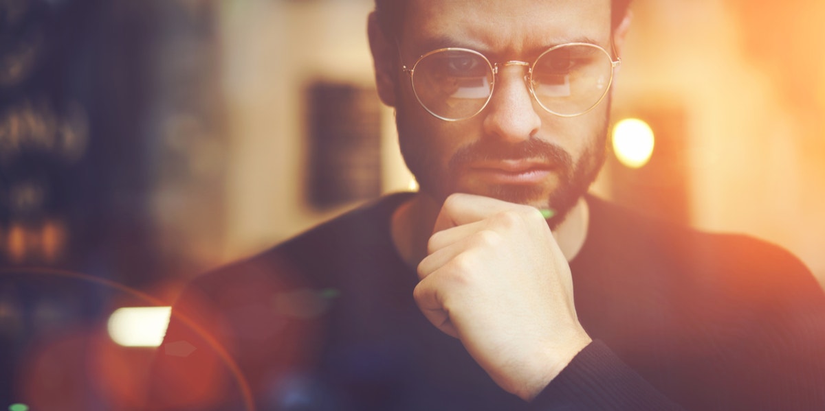 man with glasses thinking