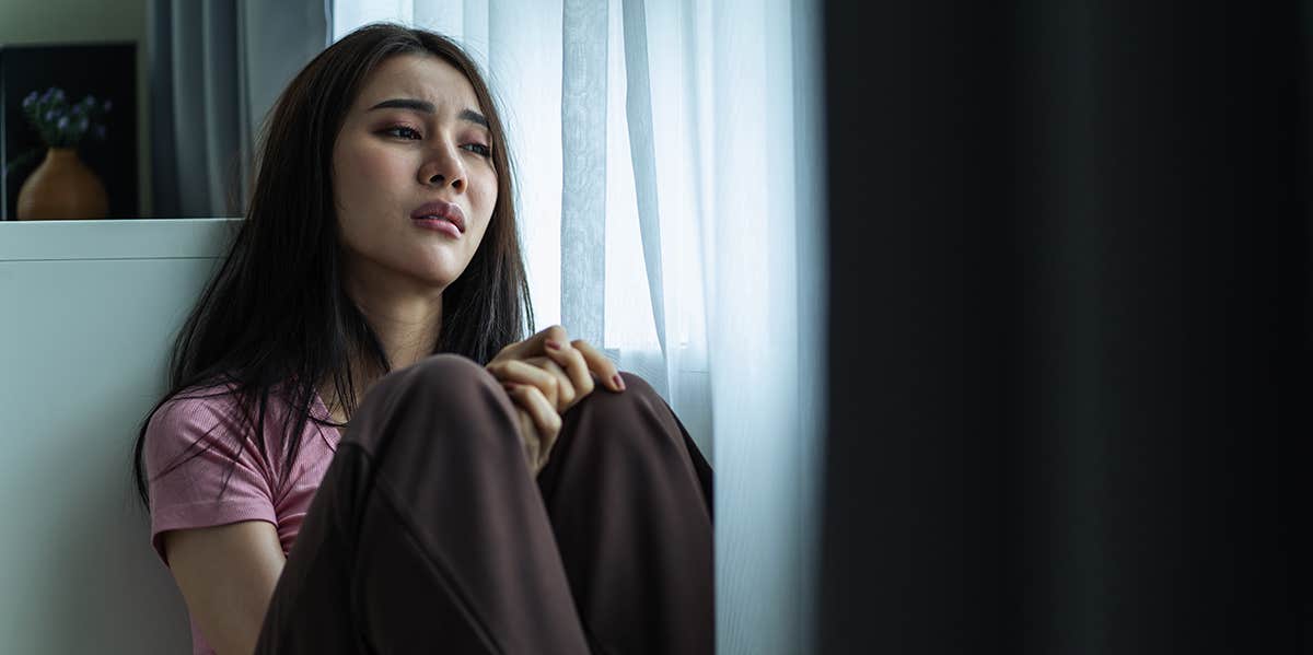 anxious woman sitting alone in room