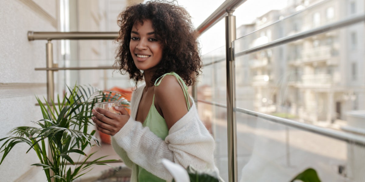 woman on balcony smiling