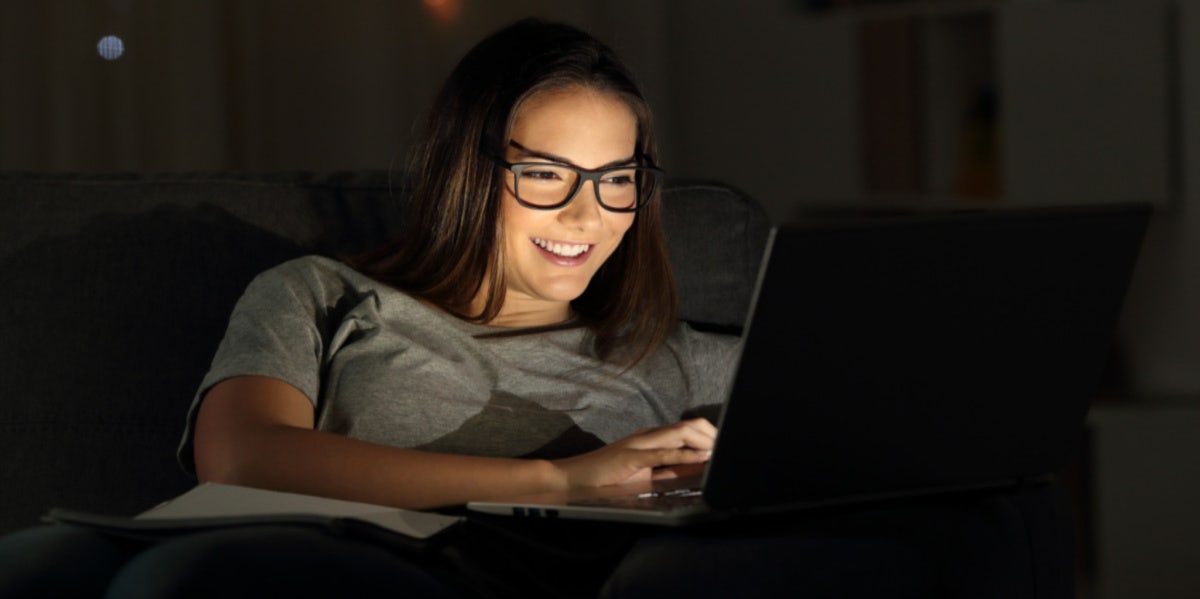 woman smiling on her laptop