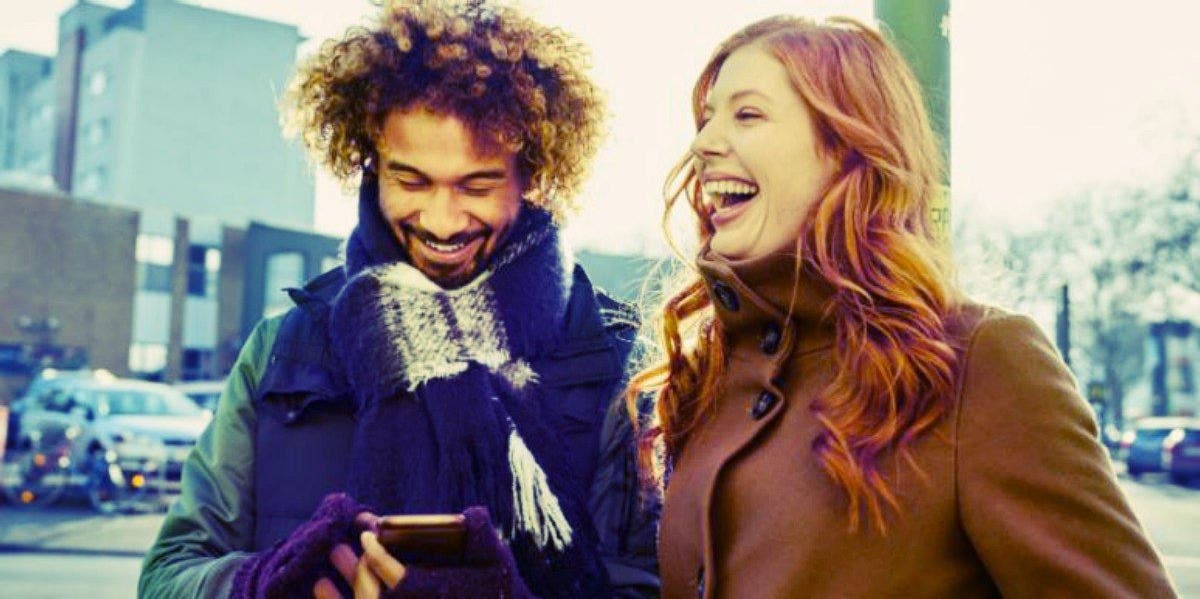 Does He Like Me? 46 Signs A Guy Is Into You man and woman laughing together