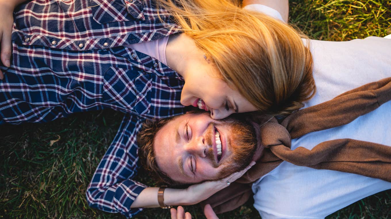 Happy couple laying on the grass 