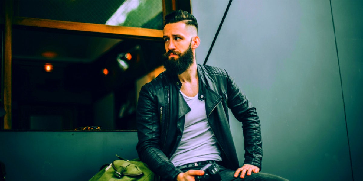 bearded man sitting on subway