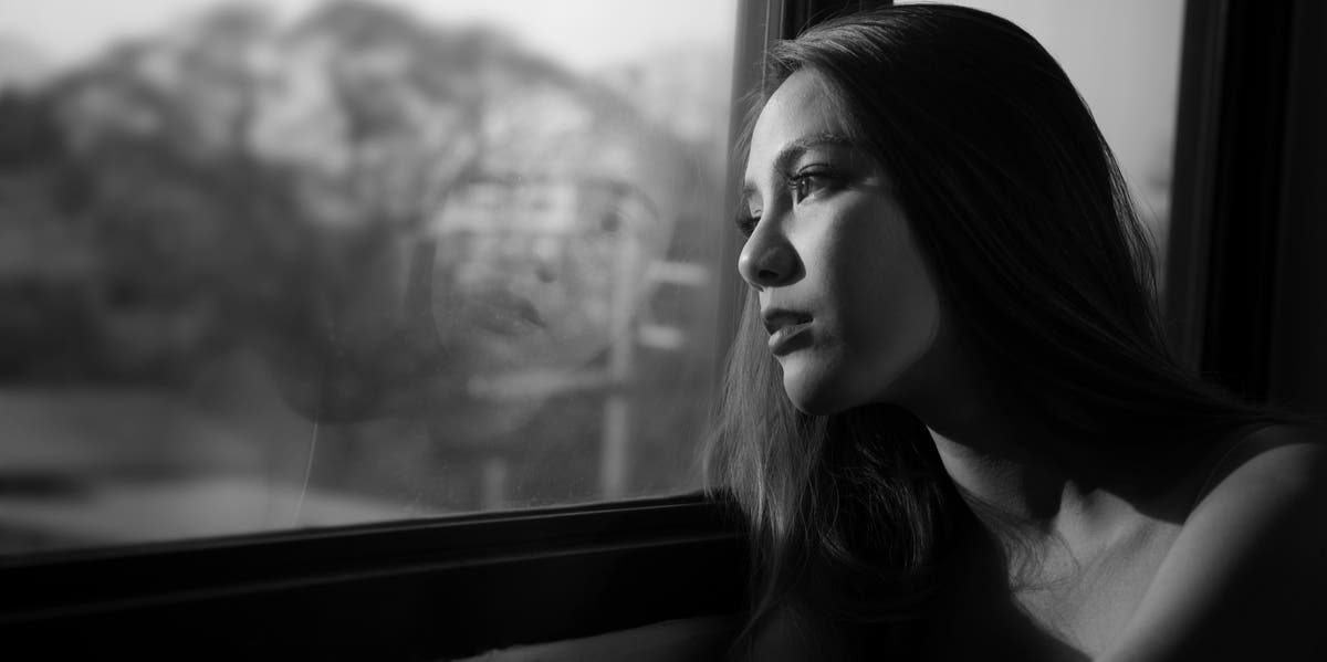 woman looking outside window