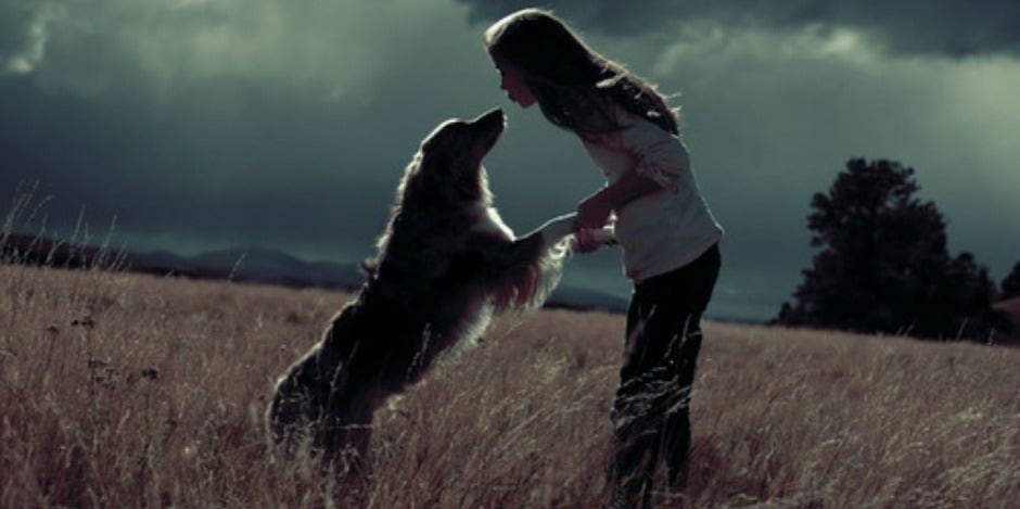 Girl kissing her dog