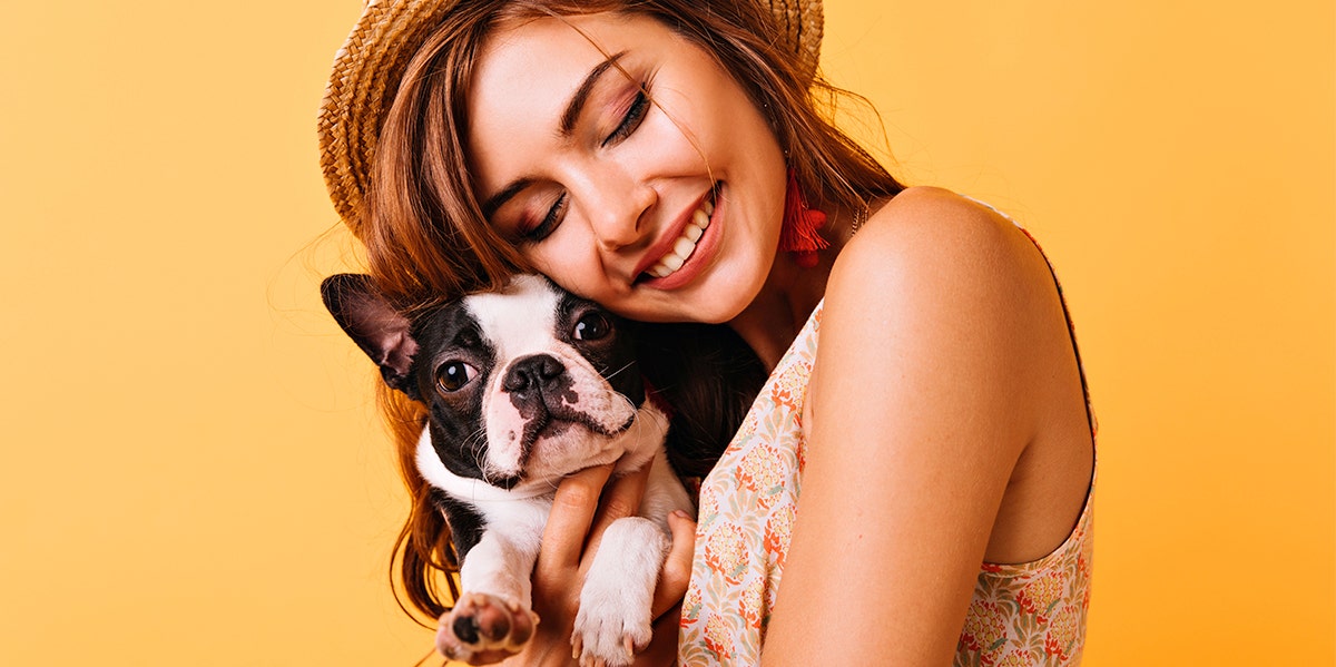 woman cuddling dog