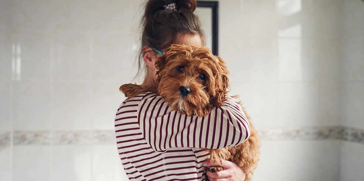 woman holding dog