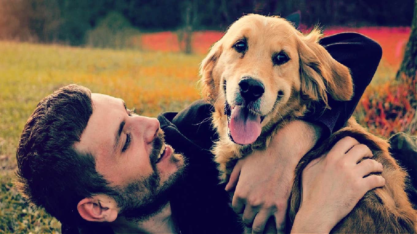 man hugging dog smiling