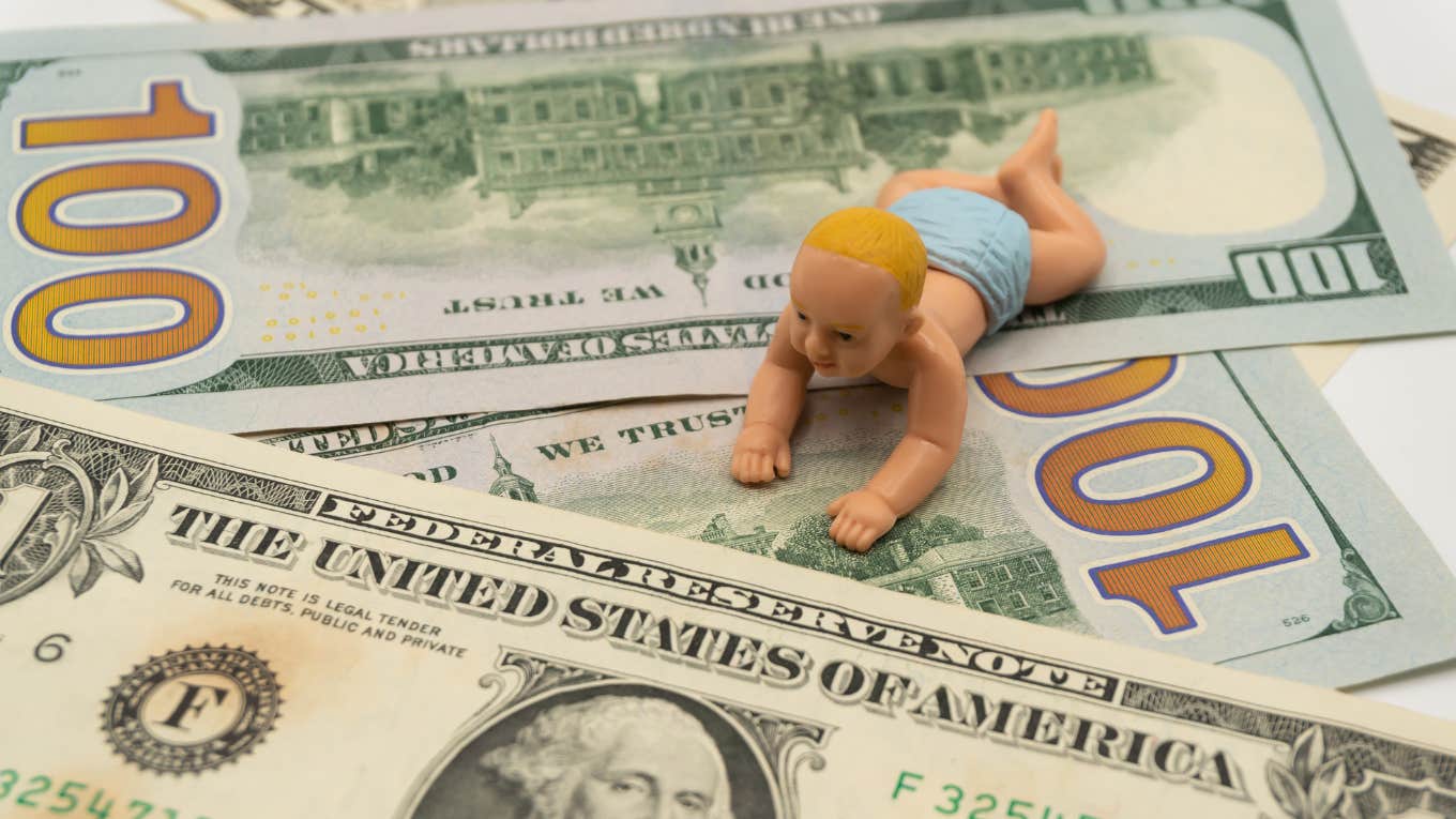 baby and dollar bills