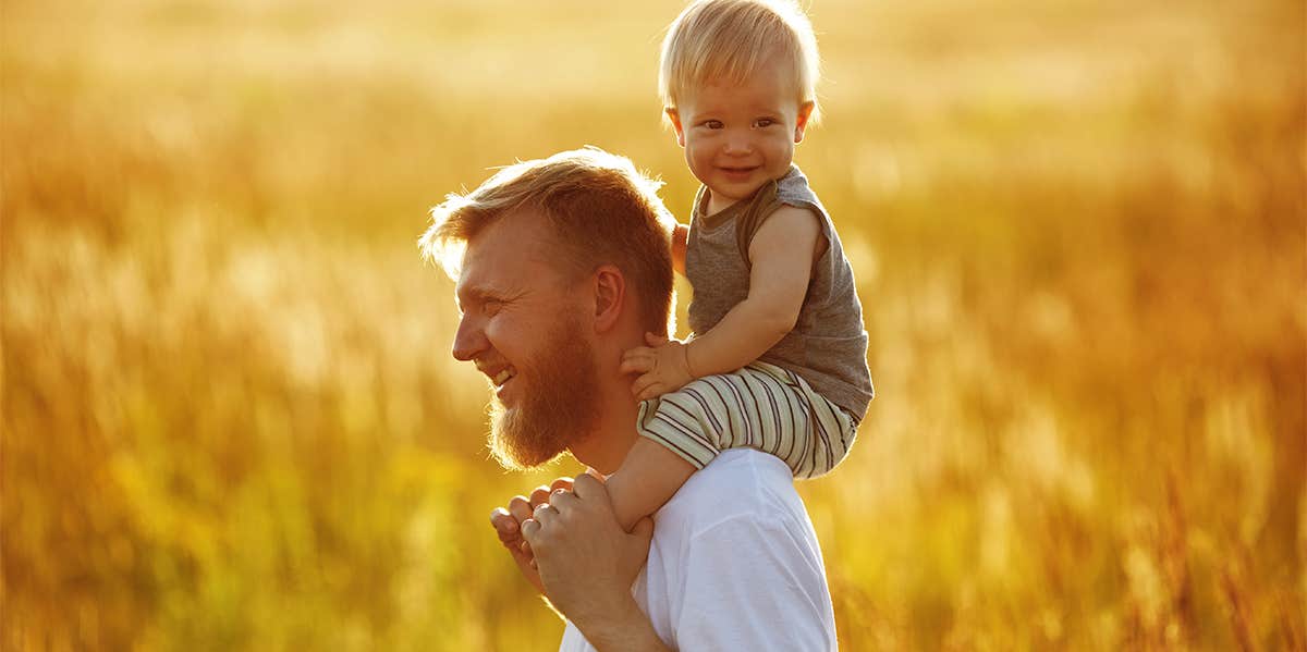 man carrying toddler