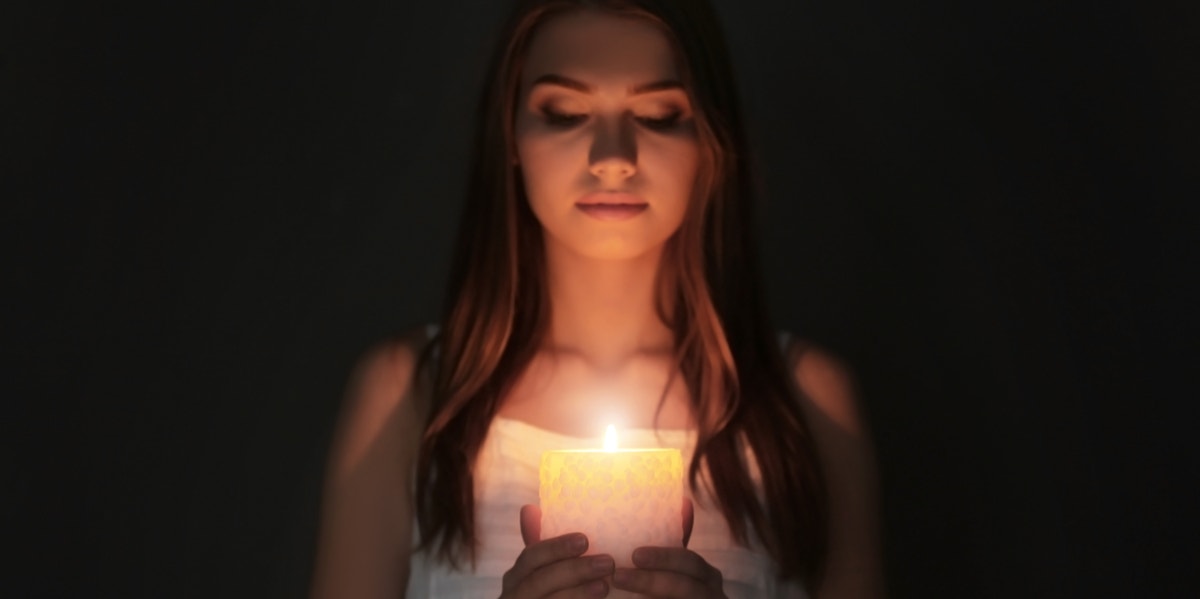 Why You Need To Stop Letting Him Dim Your Light woman with candle