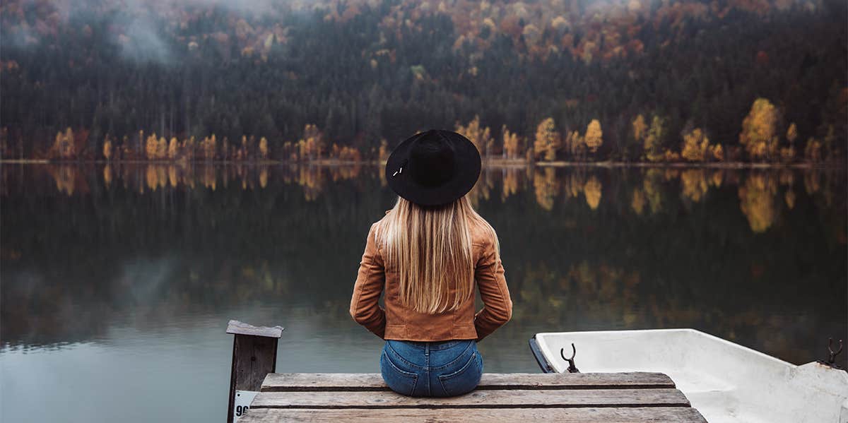 woman sitting on dock