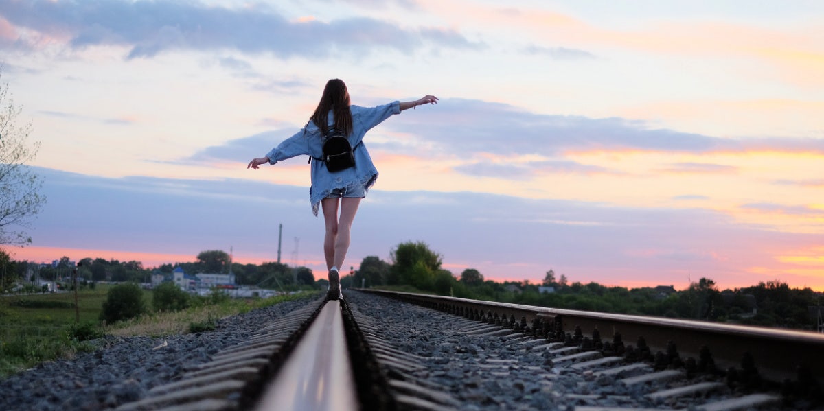 I Don't Need A Man, But That Doesn't Mean I Can't Want One woman walking on train tracks