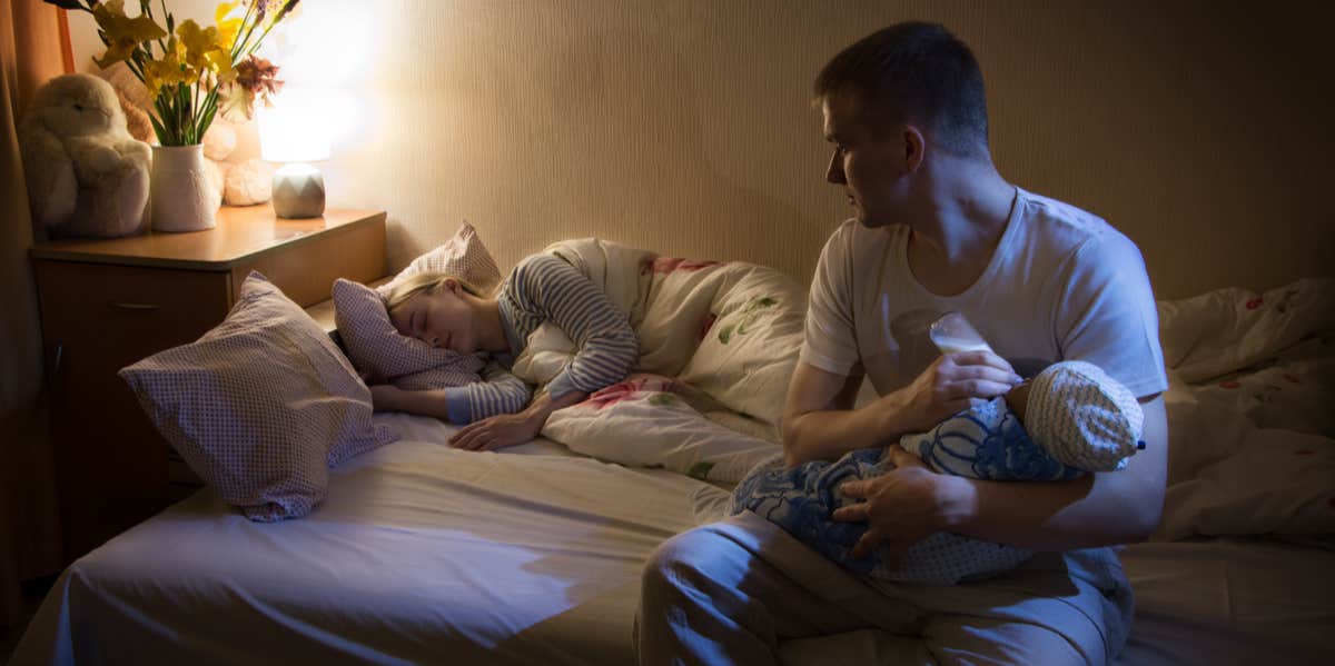 dad feeding baby late at night