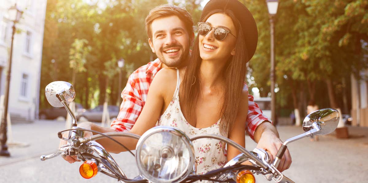 happy smiling couple on moped