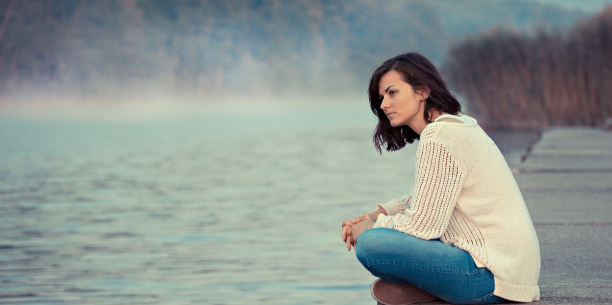 woman sitting on dock