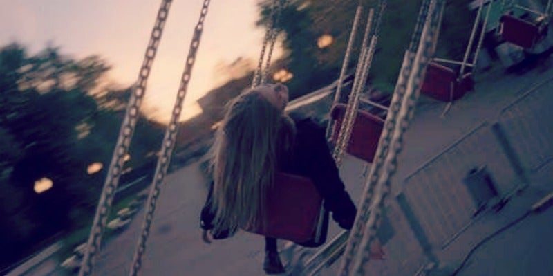woman swinging at amusement park woman swinging at amusement park